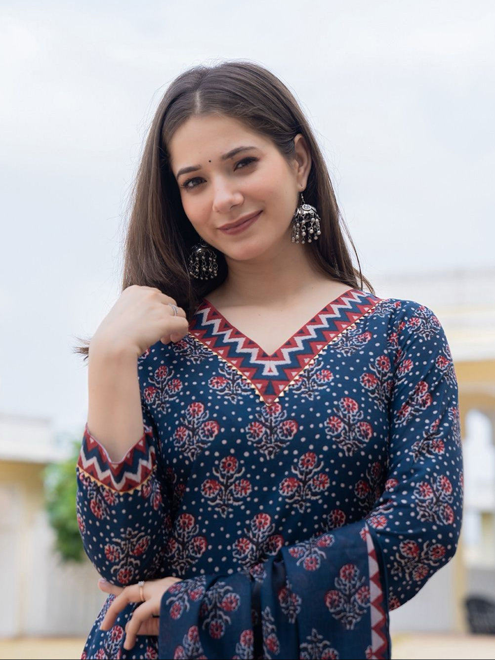 Woman wearing a blue patterned dress with a blurred background