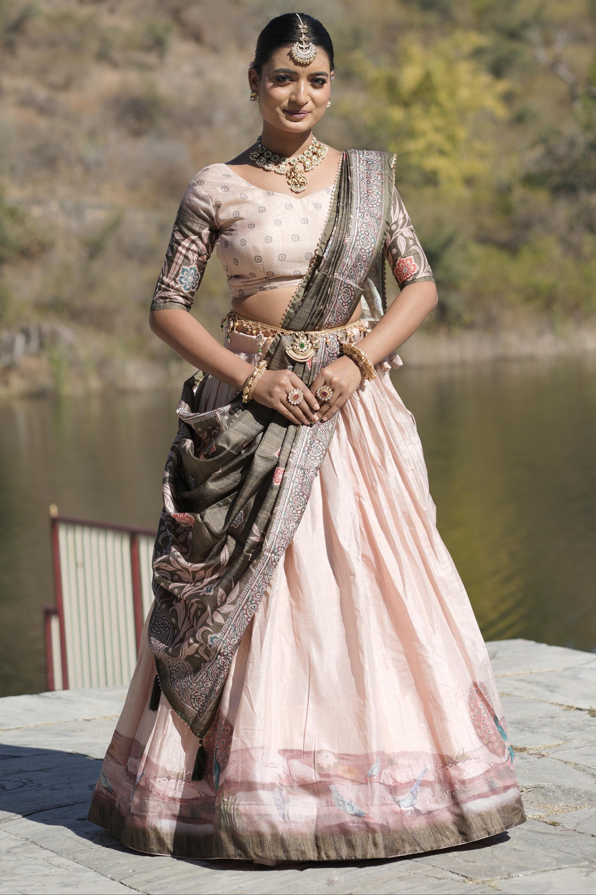 Woman in traditional saree by a lake