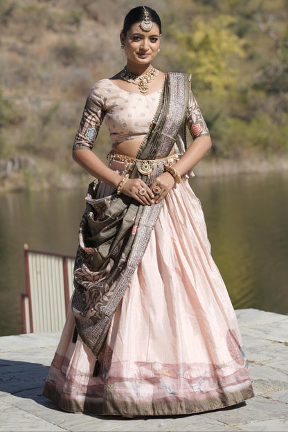 Woman in traditional saree by a lake