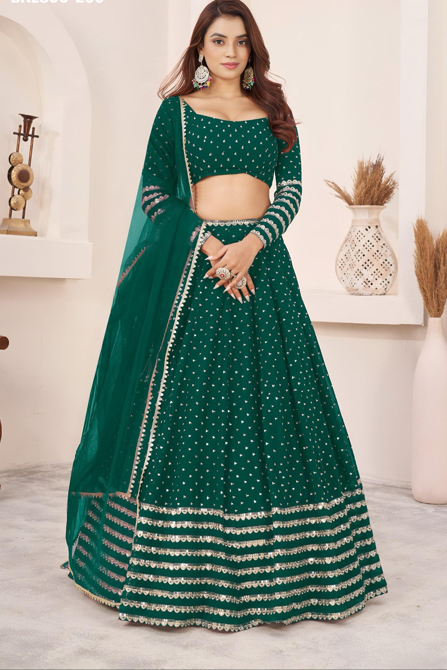 Green traditional outfit with intricate patterns on a neutral background