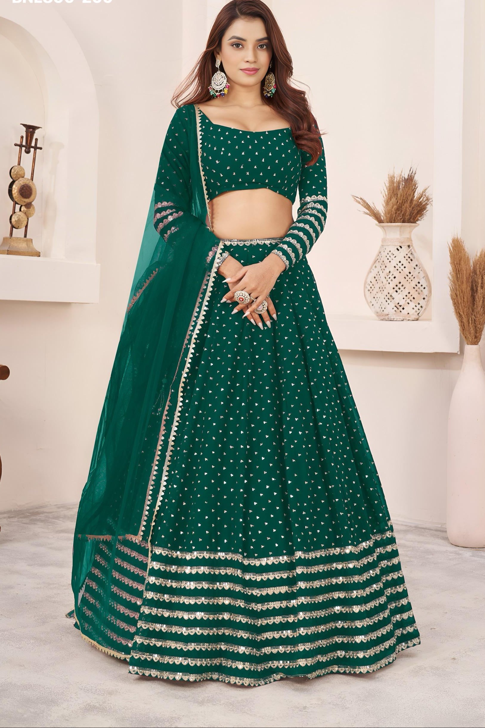 Green traditional outfit with intricate patterns on a neutral background