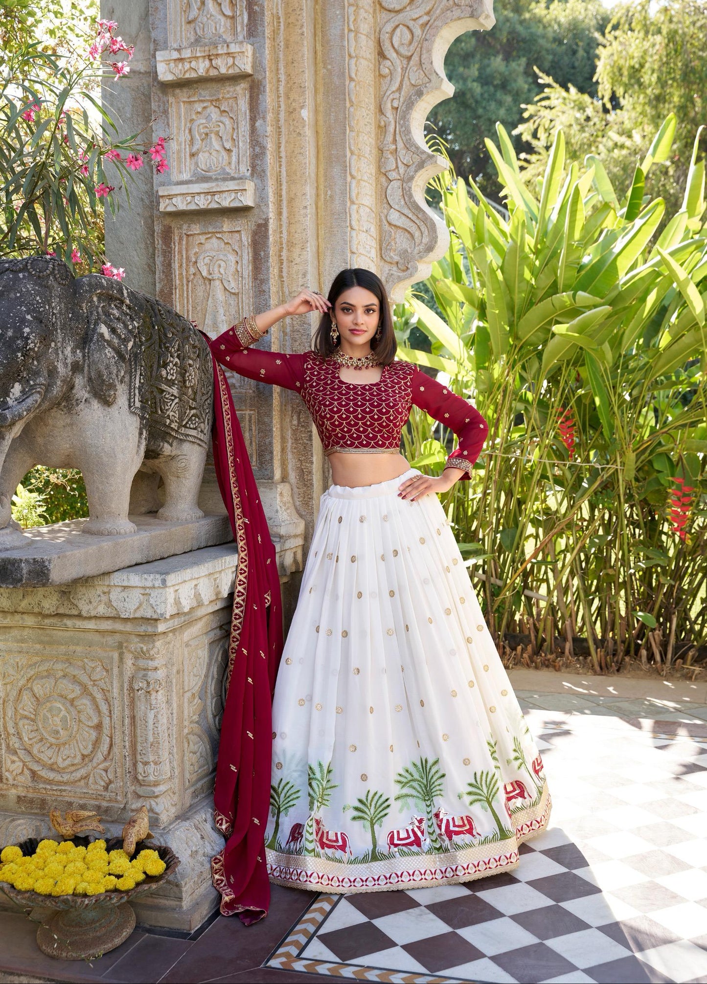 Woman in traditional red and white outfit standing in a garden setting