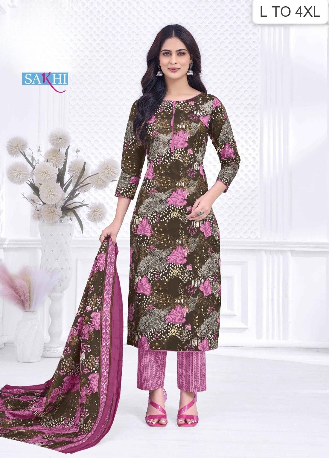 Woman wearing a floral dress with a matching dupatta in a minimalistic setting