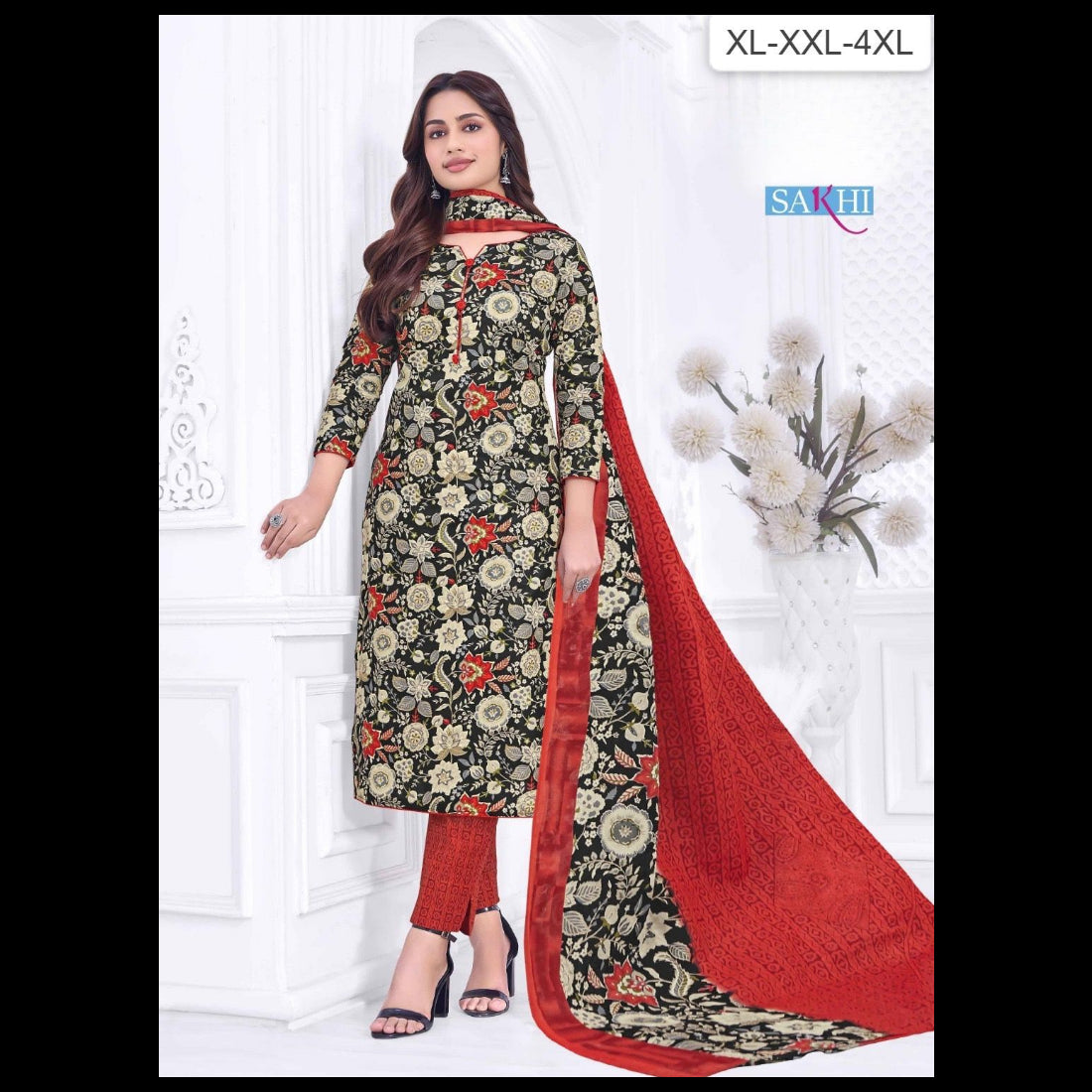 Woman wearing a floral dress with a red dupatta on a white background