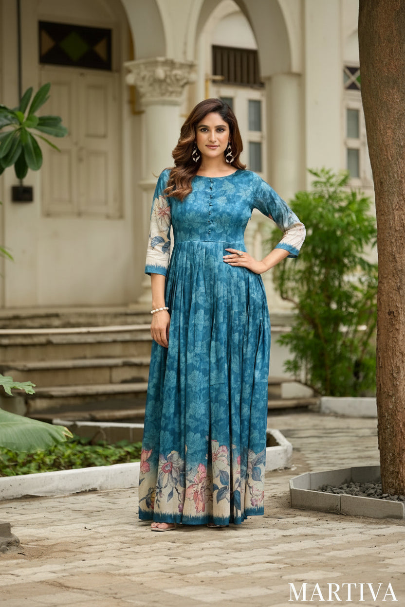 Woman in a blue floral dress standing outdoors with classical architecture in the background