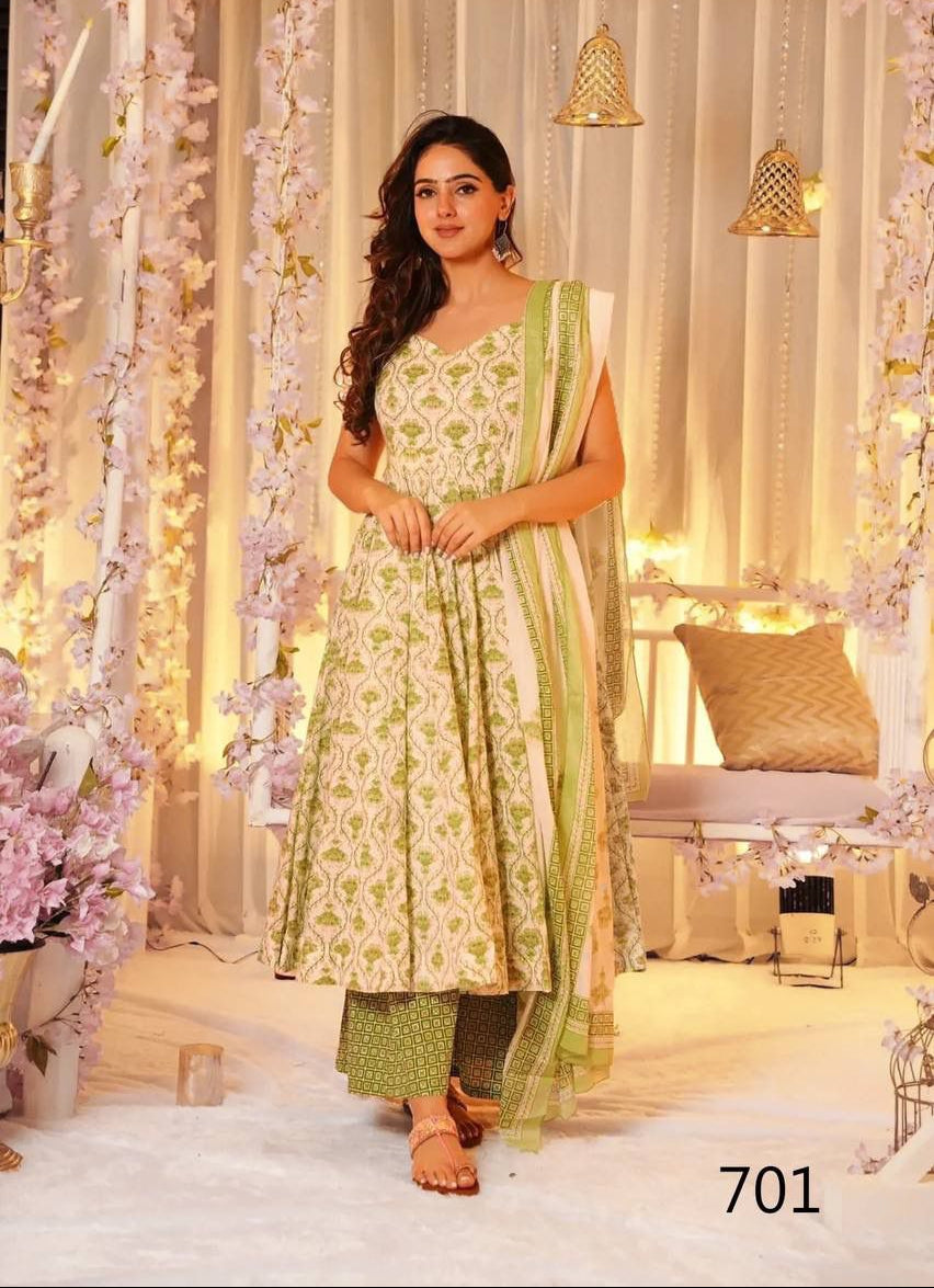 Woman in a green and white traditional outfit with a floral background