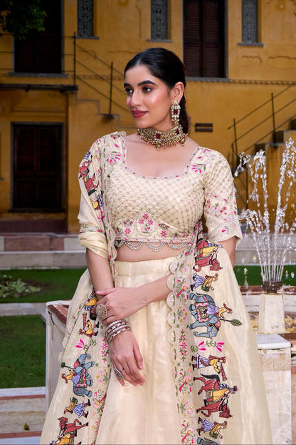 Woman in traditional outfit with floral patterns standing in front of a building with a fountain.