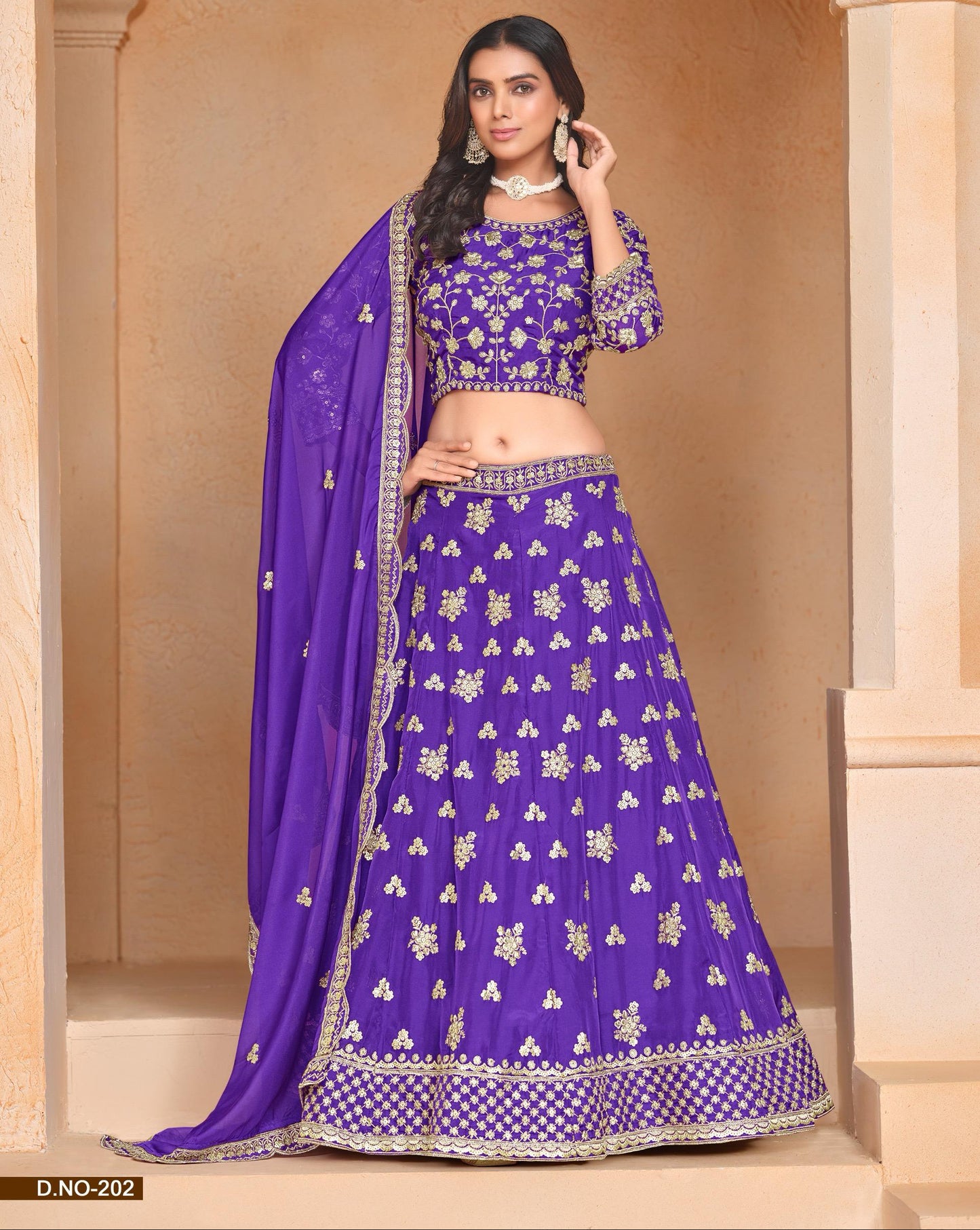 Woman wearing a traditional purple embroidered lehenga with a matching dupatta.