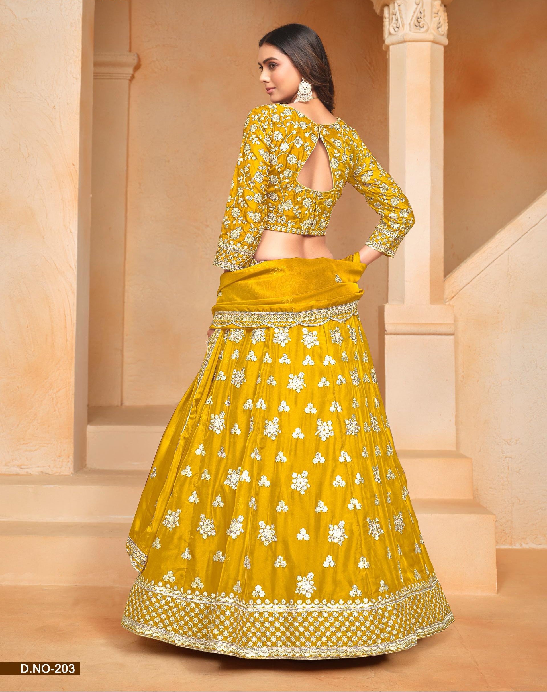 Woman wearing a yellow floral lehenga in an indoor setting