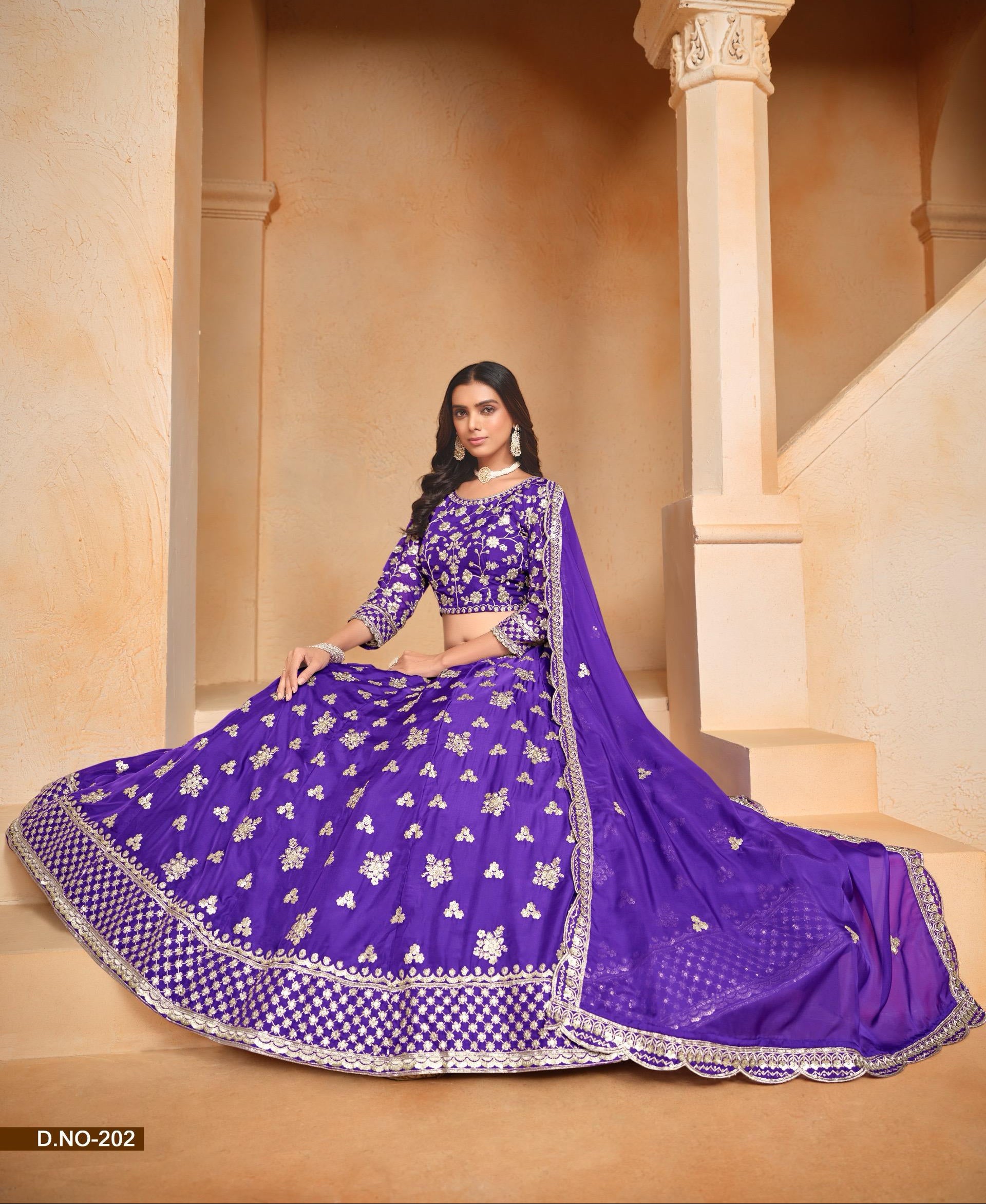 Woman in a purple embroidered traditional outfit standing in an architectural setting.