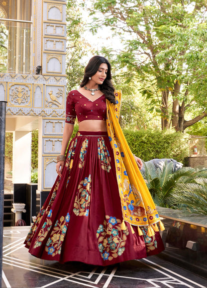 Woman in a maroon traditional outfit with a yellow dupatta in an outdoor setting
