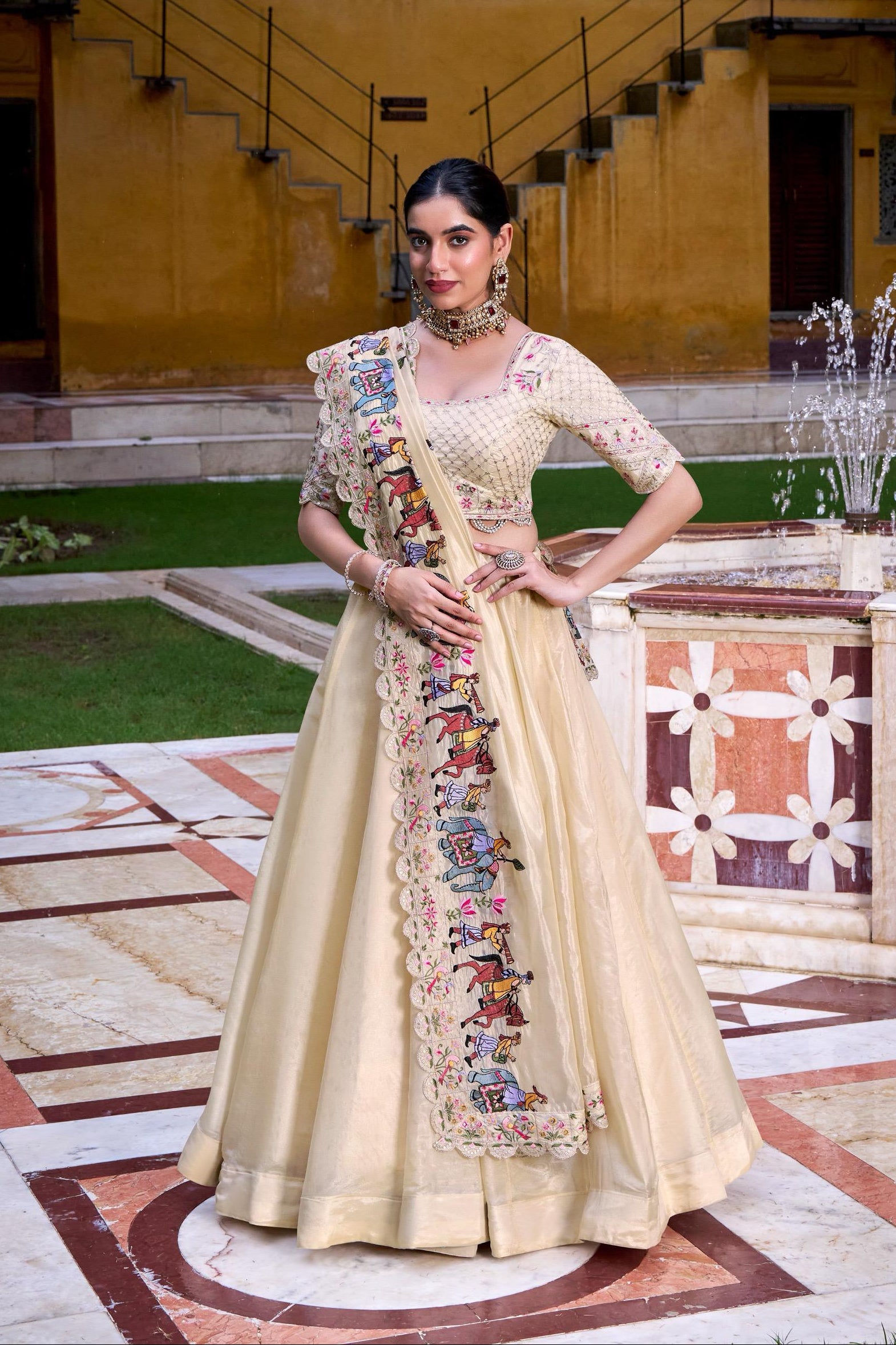 Woman in a traditional outfit standing in an outdoor setting with a fountain.