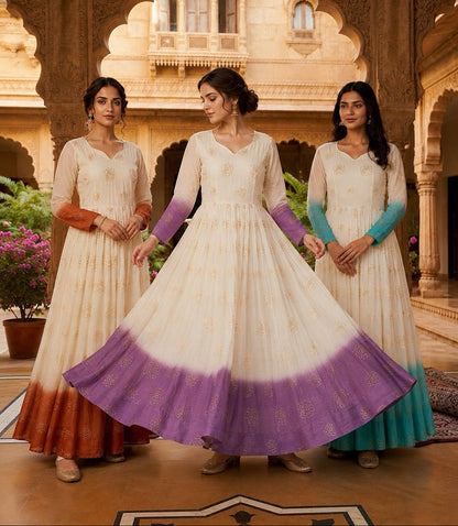 Three women in traditional dresses standing in front of an architectural background